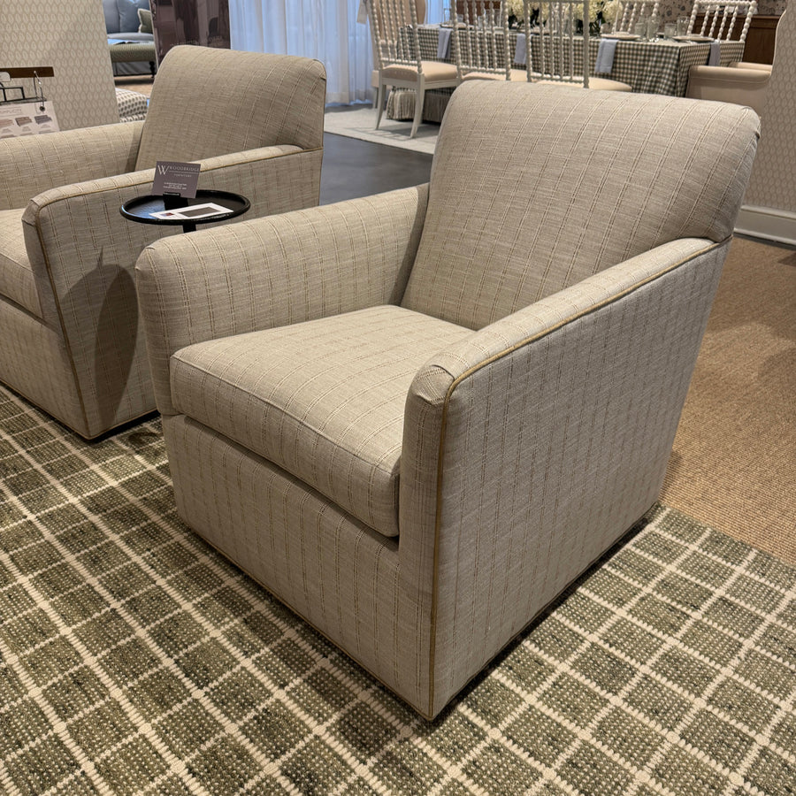 Beige armchair in a room with checkered floor and blurred background