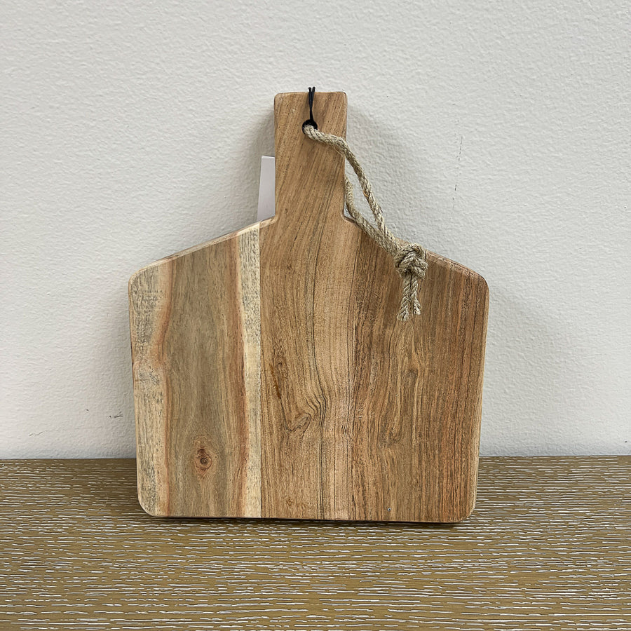 A rectangular wooden cutting board with a natural brown color, featuring a rope handle at the top.