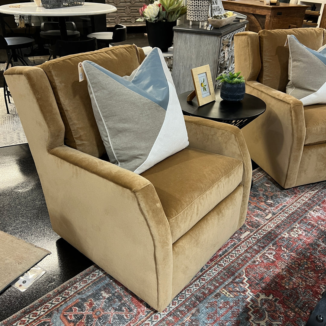 A yellow Darra swivel chair with performance fabric, featuring a classic design with armrests and a comfortable backrest, placed in a showroom setting.