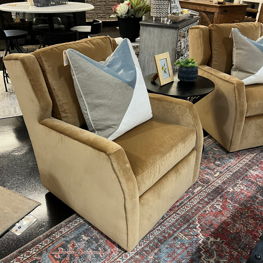 A yellow Darra swivel chair with performance fabric, featuring a classic design with armrests and a comfortable backrest, placed in a showroom setting.